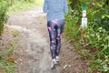 Back view legs slim running athlete woman walking exercise healthy lifestyle concept in nature pathway forest park