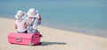 Little tourists girls with big suitcase on tropical white beach Royalty Free Stock Photo