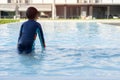 Back view of little Asian boy playing in outdoor swimming pool perpare to jumping to water on summer vacation Royalty Free Stock Photo