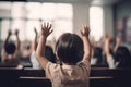 Back view of little boy raising his hands while sitting in the auditorium, Little students full rear view raising their hands, Ai Royalty Free Stock Photo