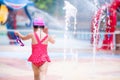 Back view of little child girl in the water park. Children wearing red swimming suit. Royalty Free Stock Photo