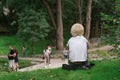 Back view of little cute boy sitting alone in the park. Happy Childhood. Outdoors and lifestyle concept Royalty Free Stock Photo