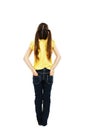 Back view of little girl with both hands in her pockets looking up at wall Royalty Free Stock Photo