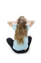 Back view of little girl confusing. Shocked young girl sitting on floor with hands on head. Rear view. Royalty Free Stock Photo