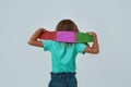 Back view of little girl hold skateboard on neck Royalty Free Stock Photo