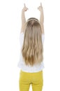 Back view of little girl pointing up at wall. Adorable girl standing pointing whit fingers. Rear view.