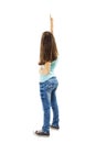 Back view of little girl points at wall. Rear view