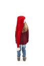 Back view of little girl in red Santa hat looking at wall. Rear view Royalty Free Stock Photo