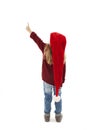 Back view of little girl in red Santa hat pointing at wall. Rear view Royalty Free Stock Photo