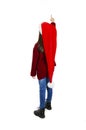 Back view of little girl in red Santa hat pointing at wall. Rear view Royalty Free Stock Photo