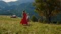 Back view mother daughter going down green hill. Woman with girl walking grass. Royalty Free Stock Photo