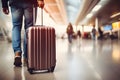 Back view of luggage being carried by man at airport