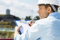 Back view of male architect with clipboard at construction site