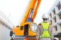 Back view of Male construction worker against crane background