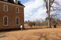 Back view of male employee in period costume walking along the reconstructed Capitol building