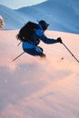 back view of male freerider speedly ride down snow-covered slopes on fresh powder snow Royalty Free Stock Photo