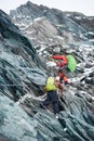 Two alpinists climbing rocky mountain.