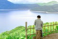 Back view of male tourist enjoy with beautiful scenery view of nature with a large reservoir above the Srinagarind Dam at Rai Ya