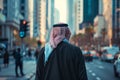 Back view of man in Arab Thawb dress in modern city street Royalty Free Stock Photo