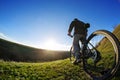 Back view of a man with a bicycle against the blue sky. cyclist rides a bicycle.