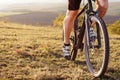 Back view of a man with a bicycle and red backpack against the blue sky. cyclist rides a bicycle. Royalty Free Stock Photo