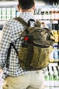 Back view of man buying drinks and food from automatic machine before travel. Conept of modern traveler lifestyle. People with