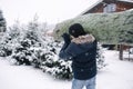 Back view of man carries Christmas tree to his home. Man buy fir tree and take in to the car. Winter mood Royalty Free Stock Photo