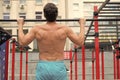 back view of man doing pull up at the gym. concept of sport. exercises in fitness gym. Male shirtless model doing Royalty Free Stock Photo