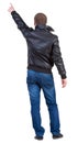 Back view of man in jacket pointing. Royalty Free Stock Photo