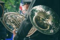 back view of a man in military uniform holding a French horn instrument