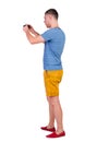 Back view of man photographing. tourist in shorts. Royalty Free Stock Photo