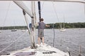 Man on sailboat holding rope docking boat Royalty Free Stock Photo