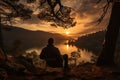 Back view of man silhouette relaxing on orange hammock between two trees lake Royalty Free Stock Photo