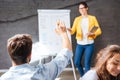 Back view of man sitting and asking questions on presentation Royalty Free Stock Photo