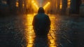 Back view of a man sitting on the road in the rain