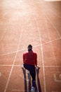 Back view of man  in starting position for running on race track in stadium Royalty Free Stock Photo