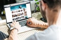 back view of man using laptop with amazon website