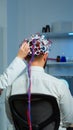 Back view of man wearing performant brainwave scanning headset