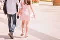 Back view of man and woman in love walking together in spring garden, having fun outdoors, relaxation on backyard, romance and Royalty Free Stock Photo