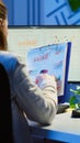 Back view of manager analysing graphics from clipboard at midnight