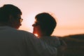 Back view a married couple a silhouette sitting on a bench. Royalty Free Stock Photo