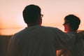 Back view a married couple a silhouette sitting on a bench. Royalty Free Stock Photo