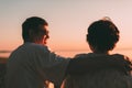 Back view a married couple a silhouette sitting on a bench. Royalty Free Stock Photo