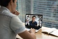 Male employee have webcam online meeting on laptop with colleagues Royalty Free Stock Photo