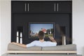 Back view of mid-adult man changing channels with television remote control in living room