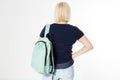 Back view of a middle-age woman with a backpack isolated over white background Royalty Free Stock Photo