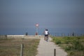 Back view of middle-aged couple, cycling on the eco pedestrian / bike path, near the sea