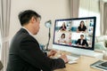 Back view of Mixed race business man talking to his colleagues about plan in video conference. Multiethnic business team using Royalty Free Stock Photo