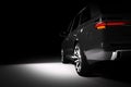 Back view of modern black SUV car in a spotlight Royalty Free Stock Photo