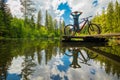 Back view of a modern e-mtb electric cyclist stretching or refreshing on a beautiful lake of Podolerteich, hidden gem in the Royalty Free Stock Photo